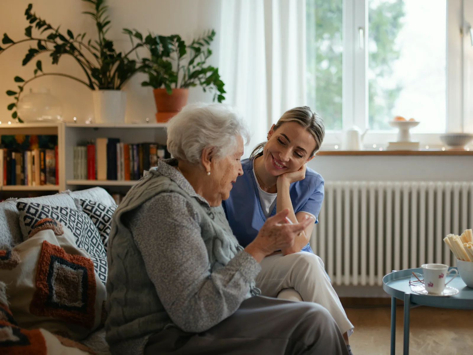 Home health clinician listening to an older adult during a visit