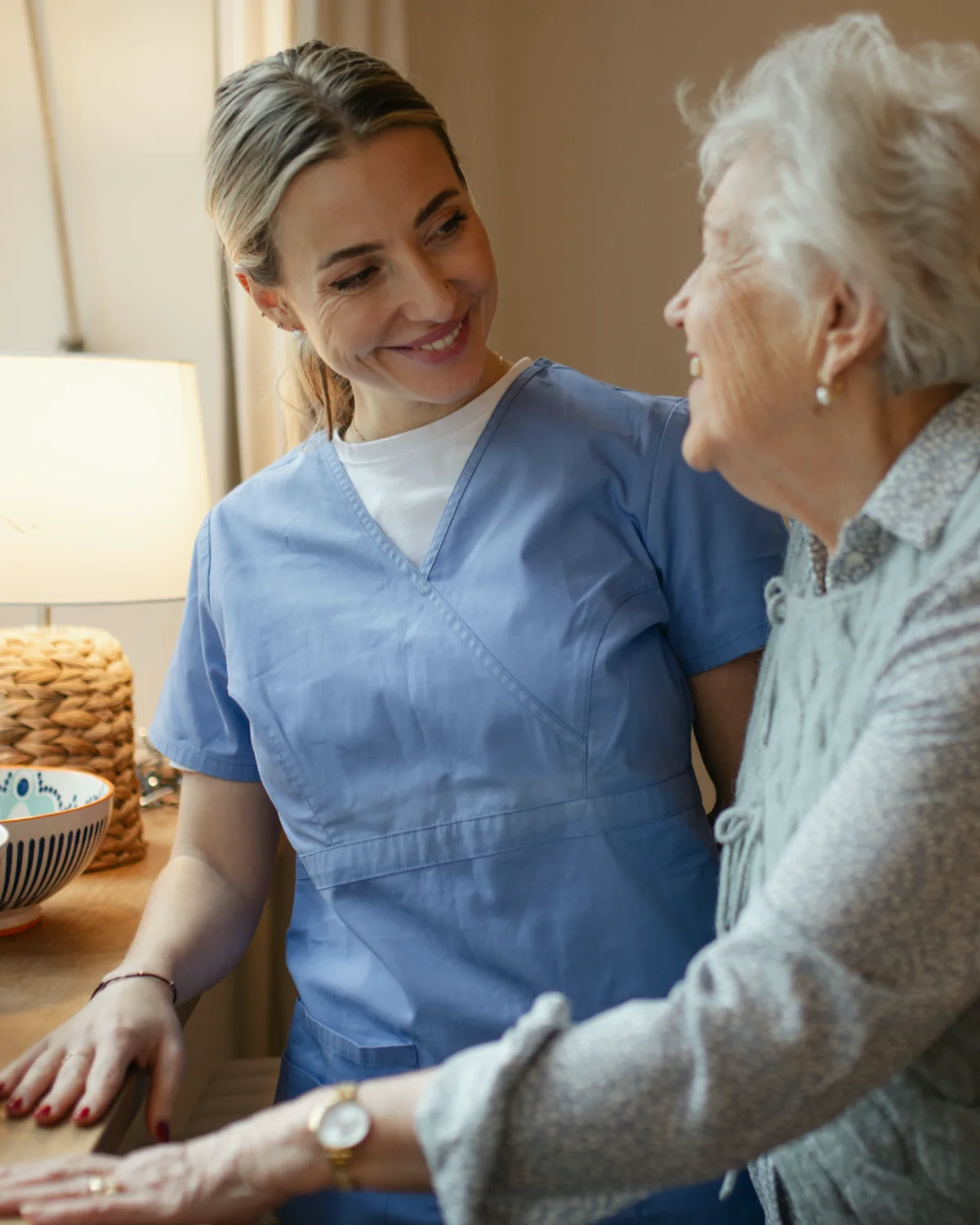 A home health professional speaking with an older adult at home